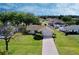 Aerial view showing a single-story house with a spacious lawn and driveway at 9390 Gulfstream Blvd, Englewood, FL 34224