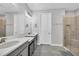 Modern bathroom with double vanity, large mirror, and a walk-in shower at 10279 Morning Mist Ln, Sarasota, FL 34241