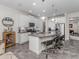 Modern kitchen with island, granite countertops, and stainless steel appliances at 8624 Rain Song Rd, Sarasota, FL 34238