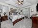 Spacious main bedroom with a king-size bed and tray ceiling at 8624 Rain Song Rd, Sarasota, FL 34238