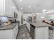 Modern kitchen with island, stainless steel appliances, and granite countertops at 8624 Rain Song Rd, Sarasota, FL 34238