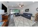 Open living area with a view of backyard, leather sofas and large TV at 8624 Rain Song Rd, Sarasota, FL 34238