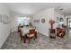 Bright dining room with tiled floor, wooden table, and chandelier at 8624 Rain Song Rd, Sarasota, FL 34238