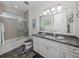 Bathroom with soaking tub, shower, and granite vanity at 8624 Rain Song Rd, Sarasota, FL 34238