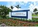 The Resort at Longboat Key Club sign surrounded by well-manicured landscaping and lush palm trees under a bright blue sky at 6603 Gulfside Rd, Longboat Key, FL 34228