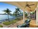 Spacious balcony with seating area overlooking the water and tropical landscaping at 3576 San Remo Ter, Sarasota, FL 34239