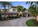 Mediterranean-style home with tile roof, paver driveway, and lush landscaping at 3576 San Remo Ter, Sarasota, FL 34239