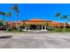 Community clubhouse with palm trees and a fountain at 4726 Sand Trap Street E Cir, Bradenton, FL 34203