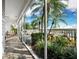 Spacious patio with water views and lush tropical landscaping at 615 Dream Island Pl # 105, Longboat Key, FL 34228