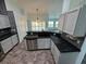 Kitchen with granite countertops, light gray cabinets, and stainless steel appliances at 5009 Sturbridge Ct, Sarasota, FL 34238