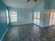Bright bedroom with light teal walls and grey tile flooring at 5009 Sturbridge Ct, Sarasota, FL 34238