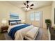 Second bedroom with a queen-size bed, and a ceiling fan at 5524 37Th E St # 0, Bradenton, FL 34203