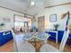 Charming dining area with glass table, four chairs, and a view into living room at 3333 26Th E Ave # 1099, Bradenton, FL 34208