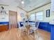 Bright dining area with glass table and four chairs, blue wainscoting, and wood flooring at 3333 26Th E Ave # 1099, Bradenton, FL 34208