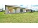 View of a large backyard featuring a well-maintained lawn, patio, and screened-in enclosures from the home at 305 Potenza Loop, Nokomis, FL 34275