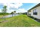 The manicured backyard slopes down to a serene pond, enhancing the property's appeal at 305 Potenza Loop, Nokomis, FL 34275