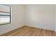 Bright bedroom with wood-look flooring, window with blinds, and ample space at 305 Potenza Loop, Nokomis, FL 34275