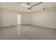Spacious garage with bright lighting and an interior access door at 305 Potenza Loop, Nokomis, FL 34275