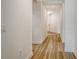 Hallway with wood-look flooring, neutral walls, and access to front entrance at 305 Potenza Loop, Nokomis, FL 34275