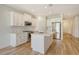 Modern kitchen with white cabinets, stainless appliances, and white quartz countertops at 305 Potenza Loop, Nokomis, FL 34275
