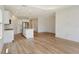Bright, open kitchen with white cabinets, stainless appliances, and wood-look flooring at 305 Potenza Loop, Nokomis, FL 34275