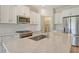 Beautiful kitchen with stainless appliances, white cabinets, and a pantry at 305 Potenza Loop, Nokomis, FL 34275