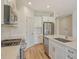 Stylish kitchen featuring stainless appliances, white cabinets, and quartz counters at 305 Potenza Loop, Nokomis, FL 34275