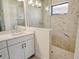 Elegant shower with neutral tiling, glass partition, shower head, and neutral walls at 305 Potenza Loop, Nokomis, FL 34275