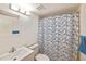 Cozy bathroom featuring a shower with a blue and white patterned curtain and clean fixtures at 6304 Pointe West Blvd # A102, Bradenton, FL 34209
