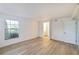 Well-lit bedroom featuring wood-look floors, a window, closet, and an adjacent bathroom at 6304 Pointe West Blvd # A102, Bradenton, FL 34209
