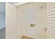 A closet with bi-fold doors including laundry hookups and a shelf at 6304 Pointe West Blvd # A102, Bradenton, FL 34209