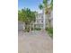 Exterior of the condo featuring well-maintained landscaping, an elevator, and multiple floors at 6304 Pointe West Blvd # A102, Bradenton, FL 34209