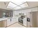 Bright kitchen with stainless steel appliances, white cabinets, and quartz countertops at 6304 Pointe West Blvd # A102, Bradenton, FL 34209