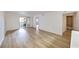 Spacious living room with modern floors, adjacent to a balcony and bathroom at 6304 Pointe West Blvd # A102, Bradenton, FL 34209
