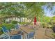 Outdoor patio area with tables, chairs, and mature trees creating a perfect community gathering space at 6304 Pointe West Blvd # A102, Bradenton, FL 34209