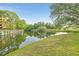 Scenic pond view surrounded by lush landscaping and mature trees, with a beautiful serene scene at 6304 Pointe West Blvd # A102, Bradenton, FL 34209