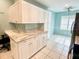 Modern kitchen featuring white cabinets, granite countertops, and a breakfast nook at 6582 Fairway Gardens Dr # 6582, Bradenton, FL 34203