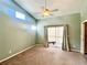 Large main bedroom with high ceilings, a ceiling fan, and patio access at 6582 Fairway Gardens Dr # 6582, Bradenton, FL 34203
