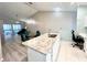 Island kitchen with granite countertops and white cabinets at 6582 Fairway Gardens Dr # 6582, Bradenton, FL 34203
