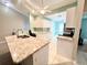Modern kitchen with white cabinets and granite countertops at 6582 Fairway Gardens Dr # 6582, Bradenton, FL 34203