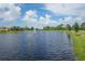 Serene lake with fountain feature and green landscaping at 305 Potenza Loop, Nokomis, FL 34275