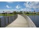 Wooden footbridge over a calm lake in a residential community at 305 Potenza Loop, Nokomis, FL 34275