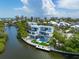 Modern home on a canal with ocean views and lush landscaping at 111 Gull Dr, Anna Maria, FL 34216