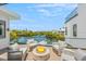 Outdoor deck with fire pit and serene water views at 111 Gull Dr, Anna Maria, FL 34216