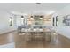 Elegant dining area with light wood table and modern chairs at 111 Gull Dr, Anna Maria, FL 34216