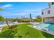 Expansive backyard with a hammock, pool, and lush landscaping at 111 Gull Dr, Anna Maria, FL 34216