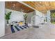 Covered patio with comfortable seating, hanging chairs, and a tranquil view at 111 Gull Dr, Anna Maria, FL 34216