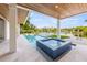 Luxury pool and spa with ample lounge space, overlooking a tranquil waterway at 111 Gull Dr, Anna Maria, FL 34216