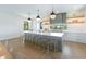 Sleek kitchen with gray island, white cabinets, and a built-in range hood at 111 Gull Dr, Anna Maria, FL 34216