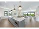 Modern kitchen with a large island, stainless steel appliances, and hardwood floors at 111 Gull Dr, Anna Maria, FL 34216